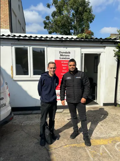 BookMyGarage employee standing outside Dundalk Motors London with the garage owner.